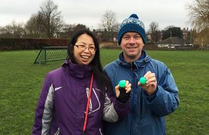 Two field users holding up numbered balls