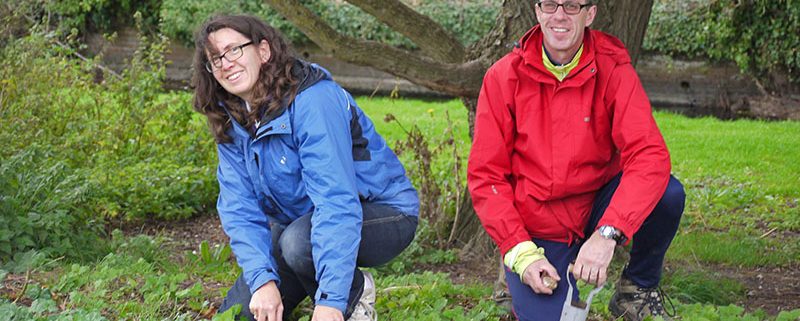 Two volunteers planting bulbs